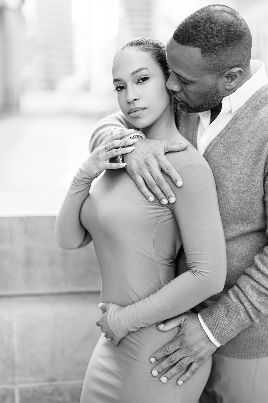 A black and white portrait of a couple in an intimate embrace, capturing a moment of affection and connection.