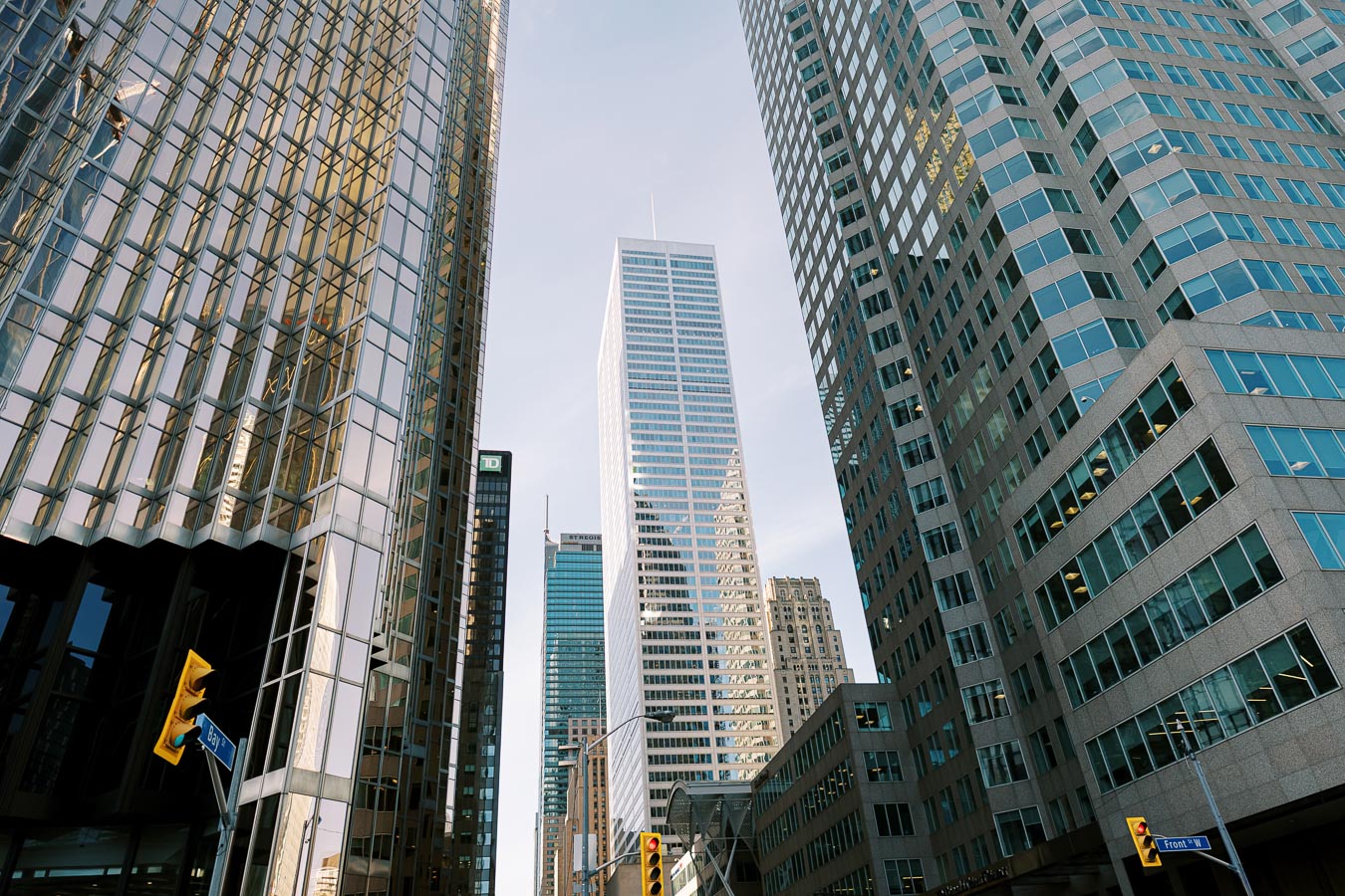 Skyscrapers in a city with Bay Street and Front Street signs visible, showcasing modern architecture.