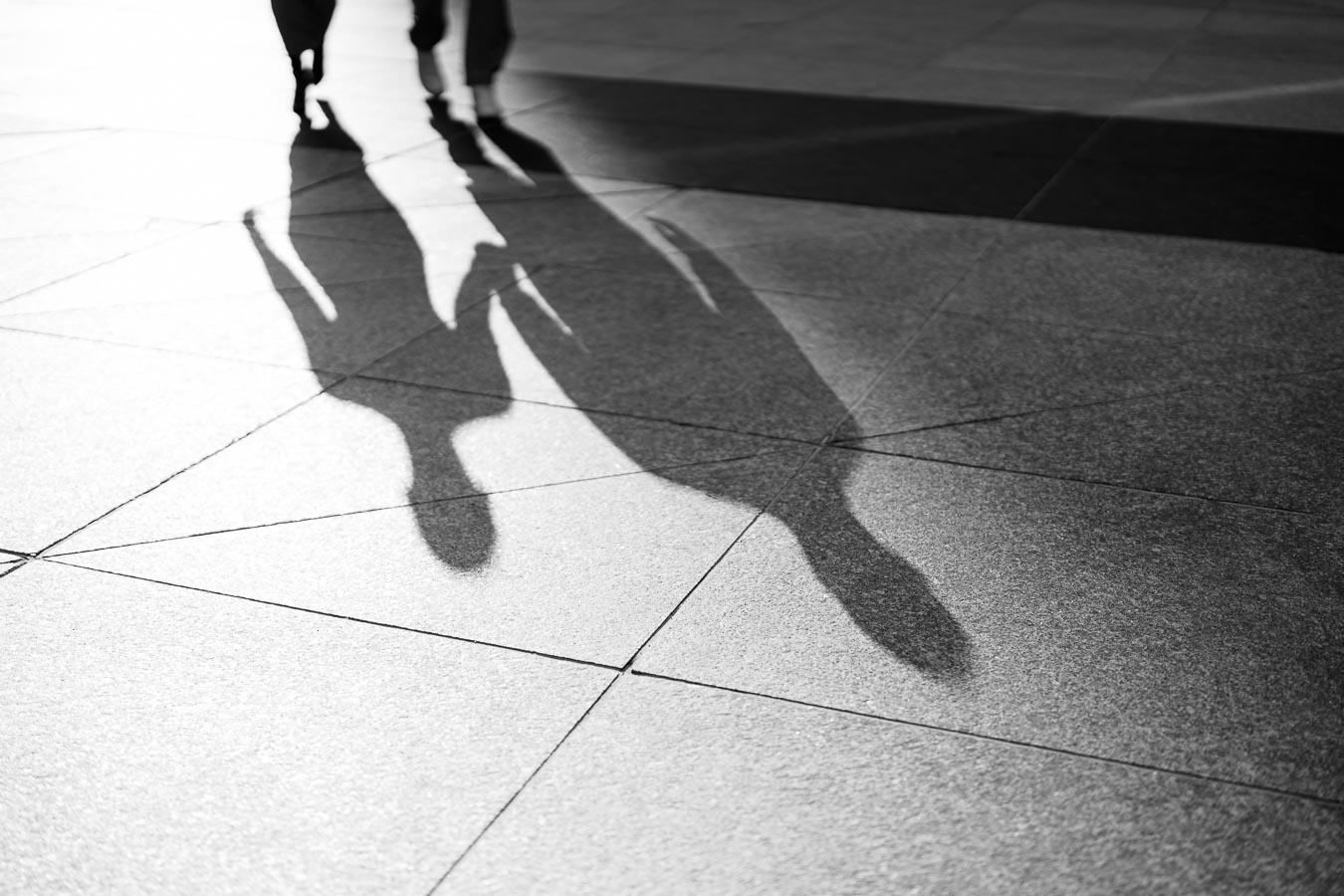 Black and white photo of couple’s shadows holding hands during a downtown Toronto engagement session