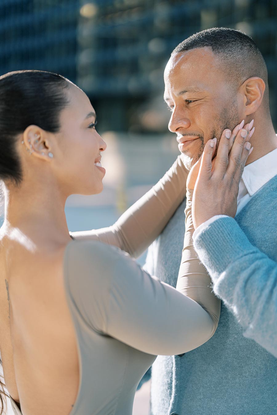 A couple shares an intimate moment, gazing into each other's eyes with affection.