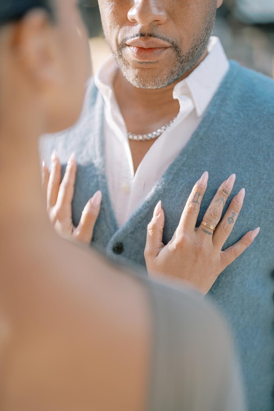 Close-up of Maria Castillo’s hands resting on DeVon Franklin’s chest during their downtown Toronto engagement session