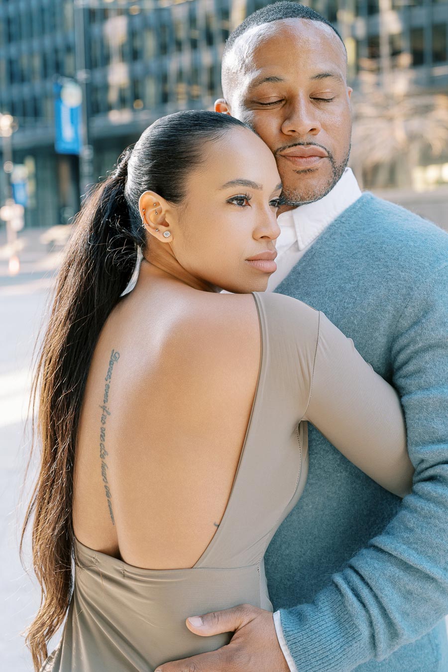 DeVon Franklin and Maria Castillo embracing during their downtown Toronto engagement shoot in soft morning light