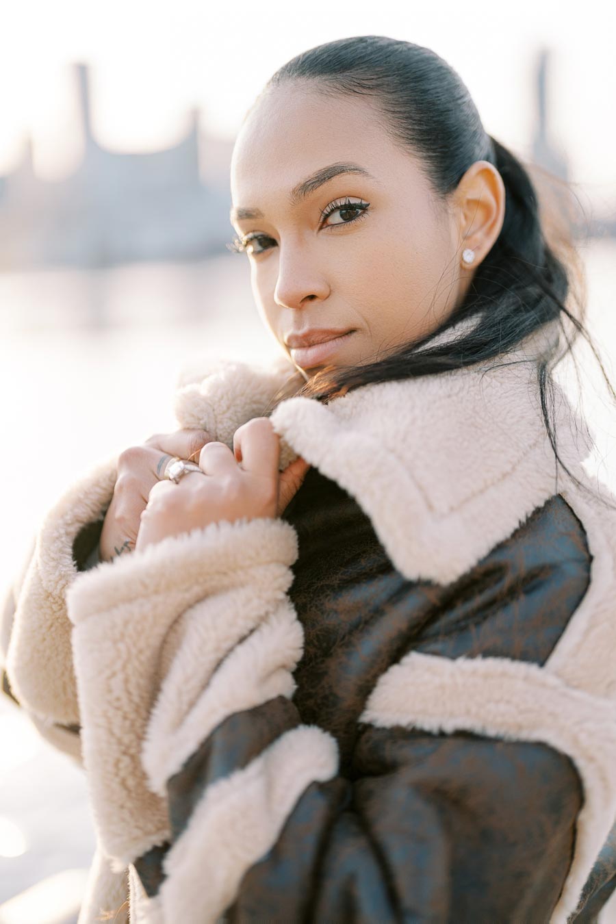 Close-up portrait of engaged woman in shearling coat by the Toronto waterfront
