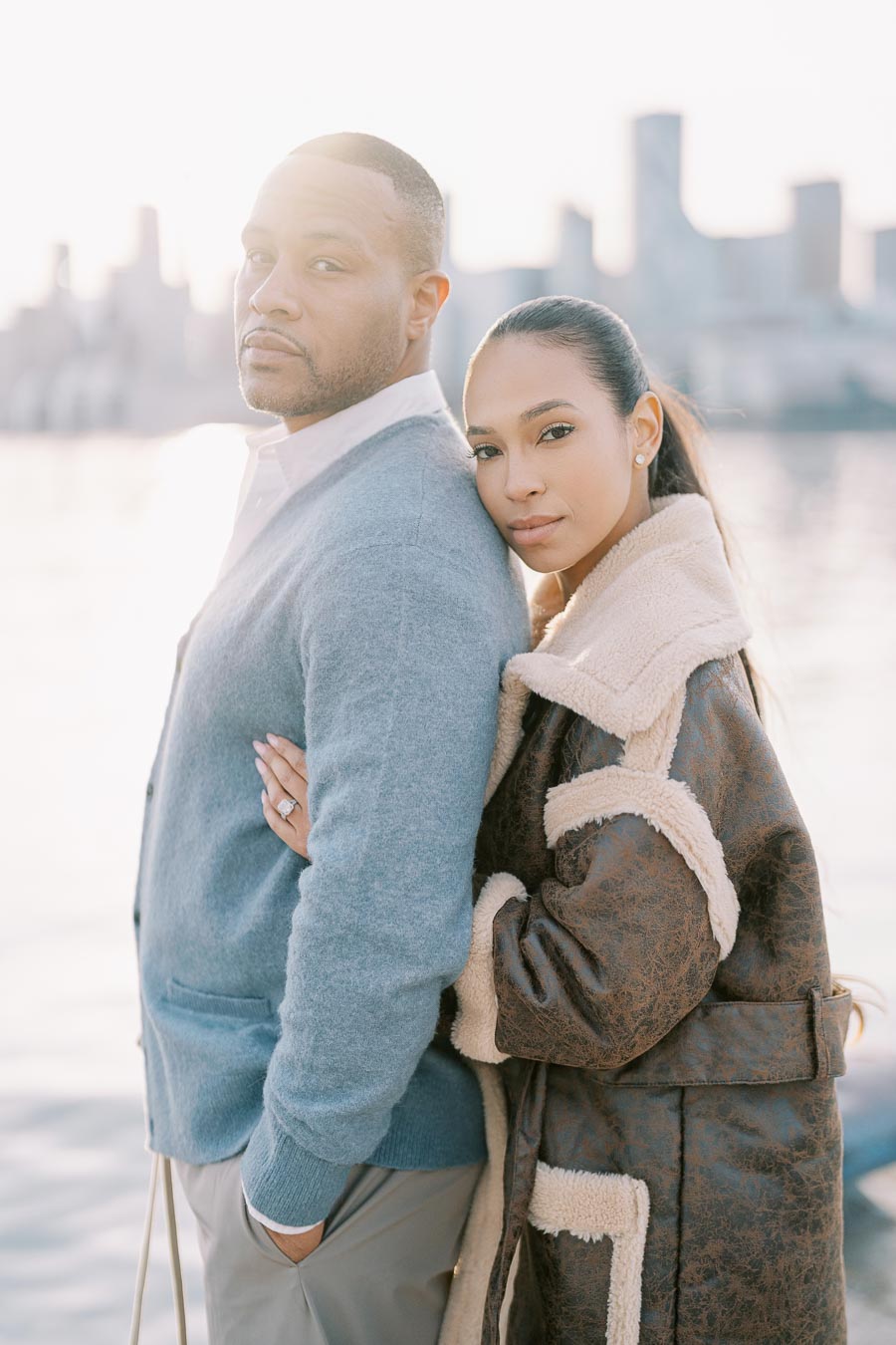 Woman embracing fiancé from behind during waterfront engagement photoshoot in Toronto