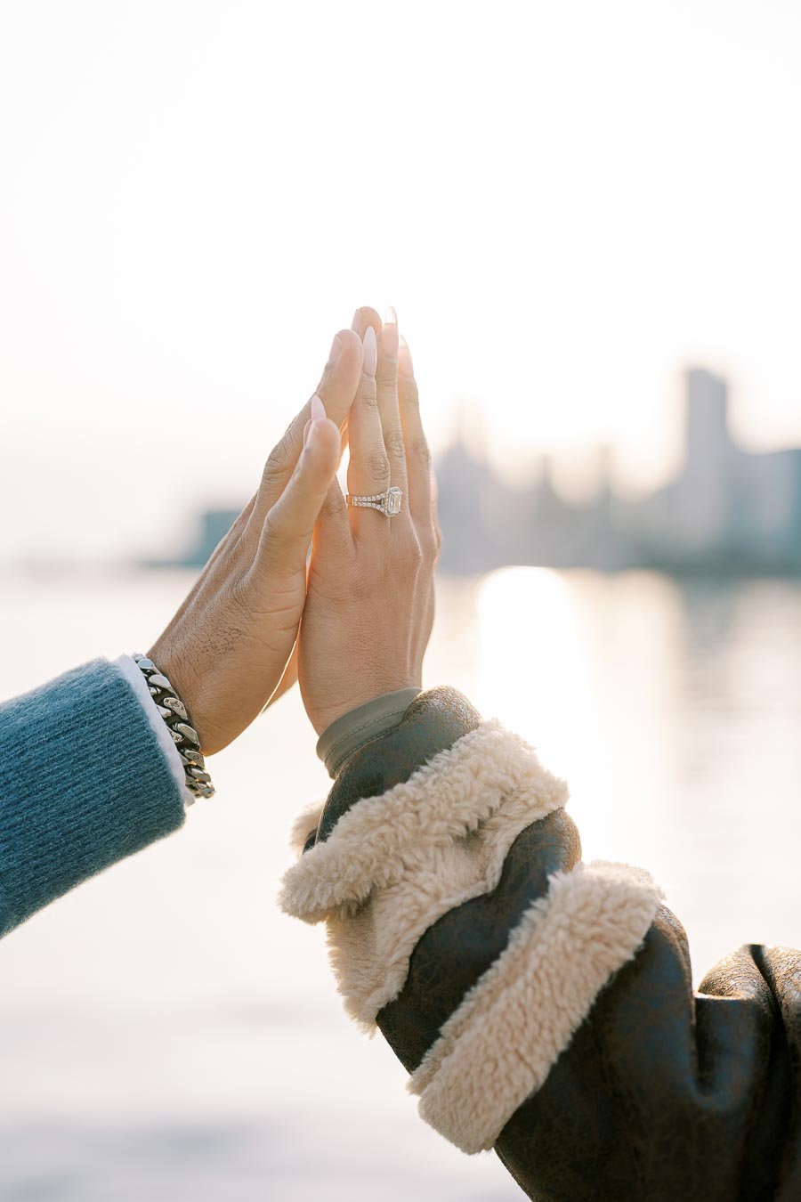 Close-up of couple’s hands with engagement ring during waterfront photoshoot in Toronto