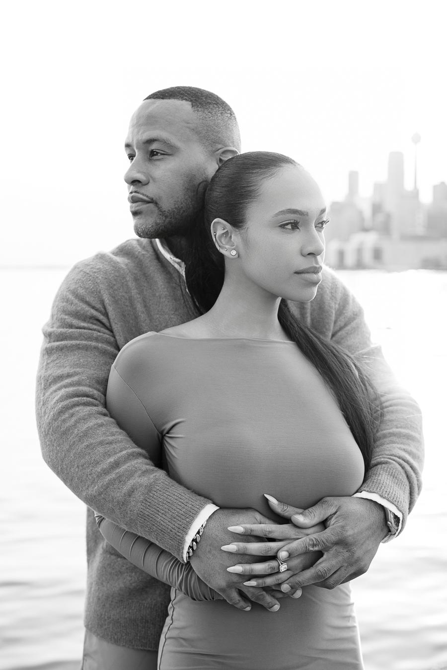 DeVon Franklin embracing Maria Castillo from behind during their engagement shoot in Toronto