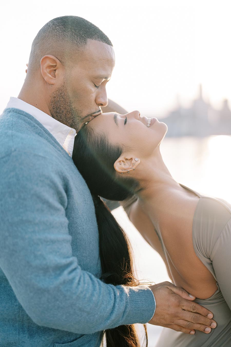DeVon Franklin kissing Maria Castillo on the forehead during their engagement session in Toronto