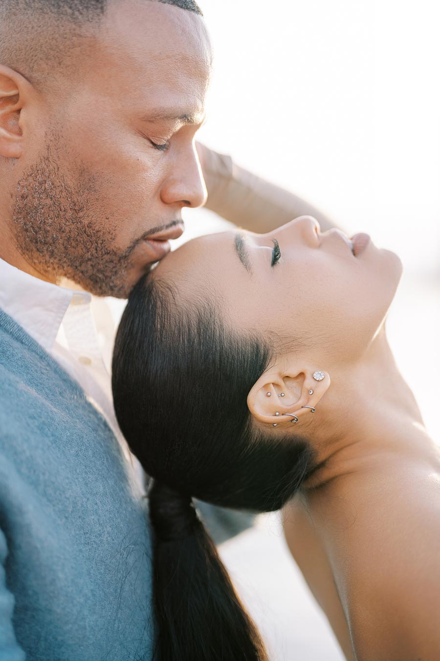 A tender moment captured between a couple, highlighting intimacy and affection.