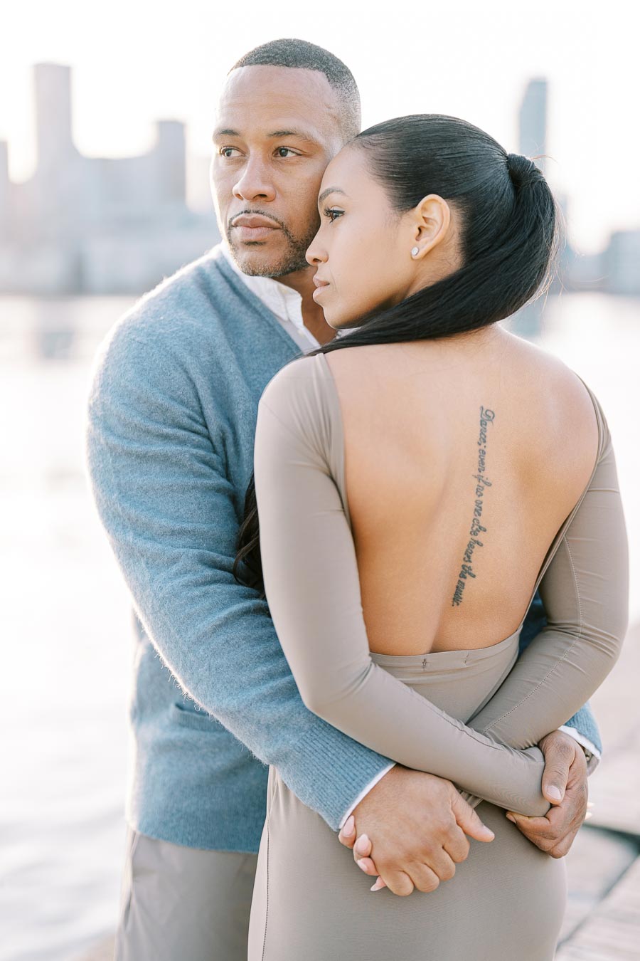 DeVon Franklin embracing Maria Castillo from behind during their engagement session in Toronto