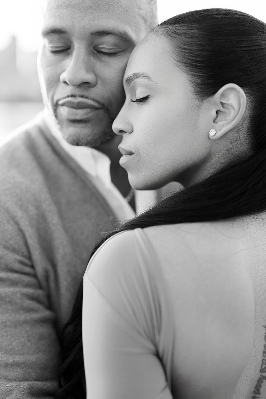 Close-up of DeVon Franklin and Maria Castillo with eyes closed, embracing gently during their Toronto engagement session