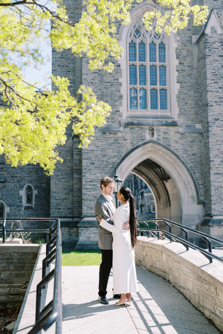 Couple standing close together during an engagement session at the University of Toronto.