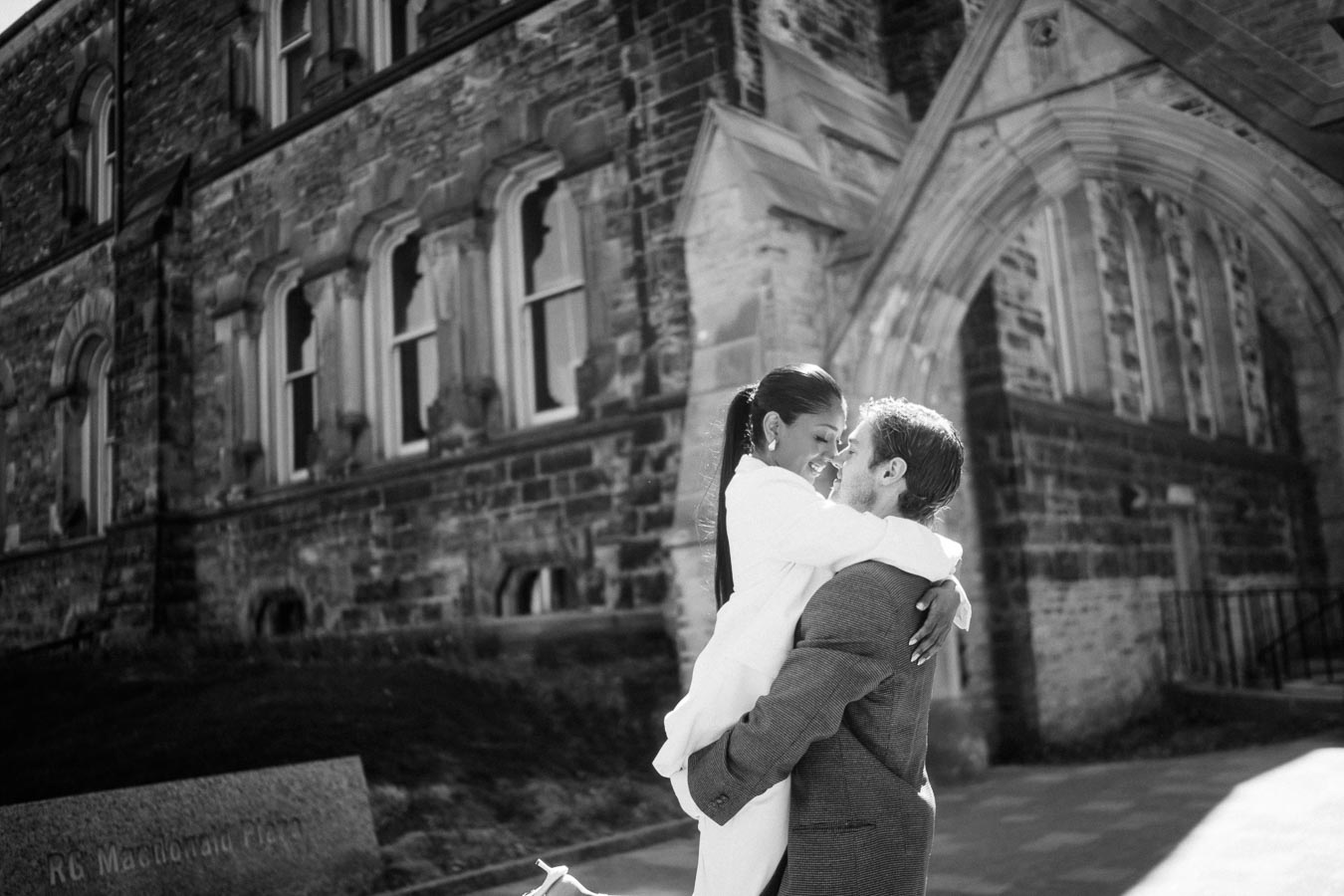 Cecilia and Julian posing for an engagement photo at the University of Toronto