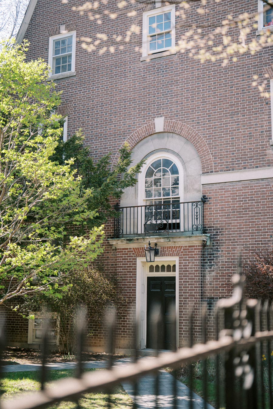 Historic brick architecture with arched window and balcony at University of Toronto