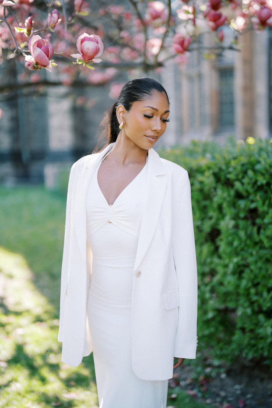 Portrait of bride-to-be in white dress under magnolia blossoms at University of Toronto
