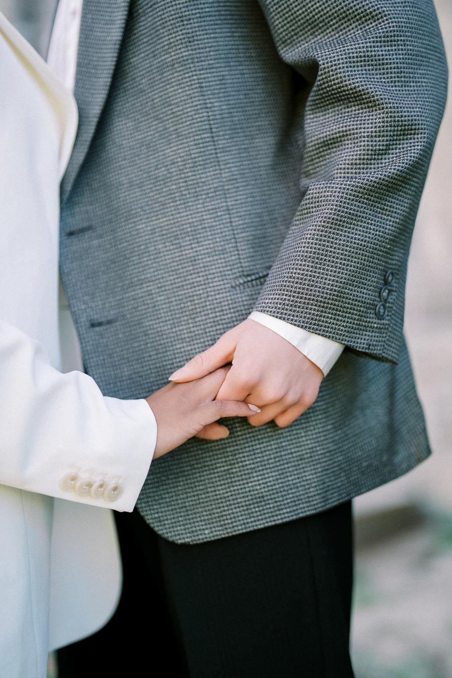 Close-up of engaged couple holding hands during photoshoot at University of Toronto