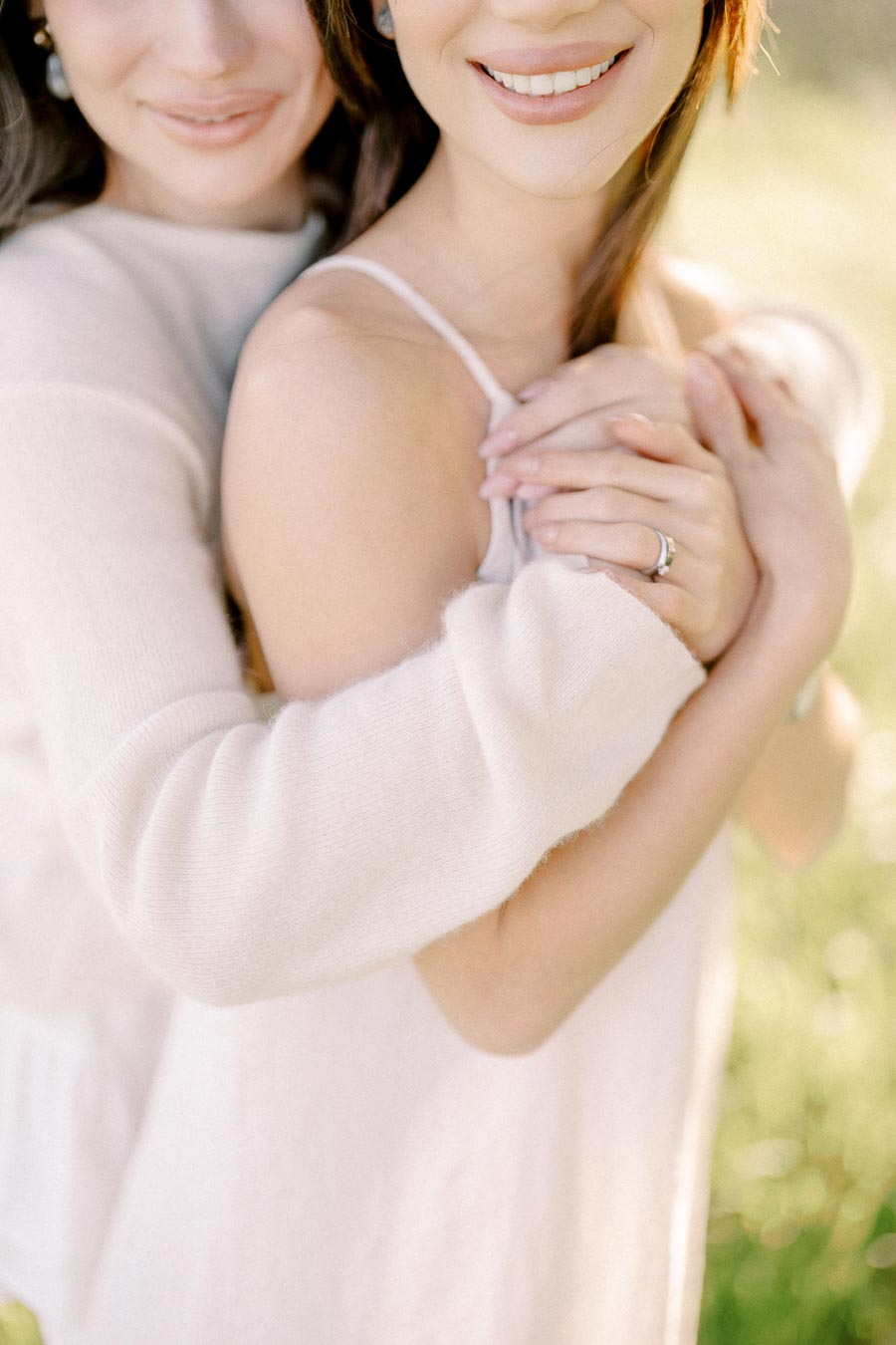 A couple embracing lovingly in a sunlit field, highlighting affection and togetherness with soft focus and warm lighting.