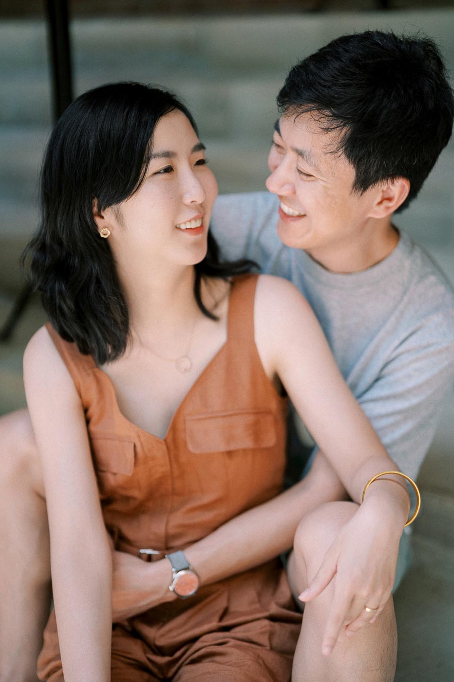 A happy couple sharing a moment together, smiling and looking into each other's eyes.
