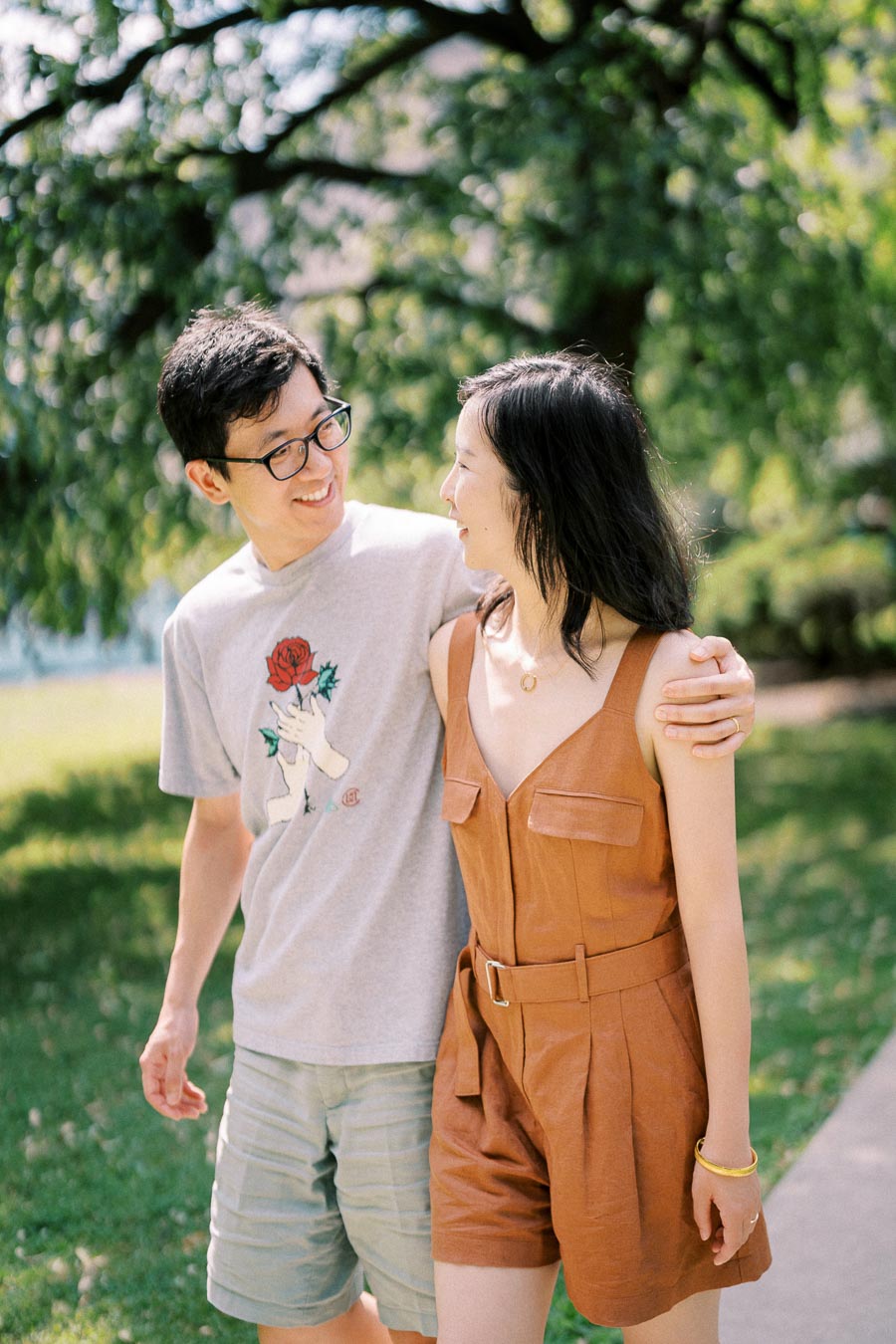 A couple enjoying a sunny day outdoors, sharing a joyful moment together.