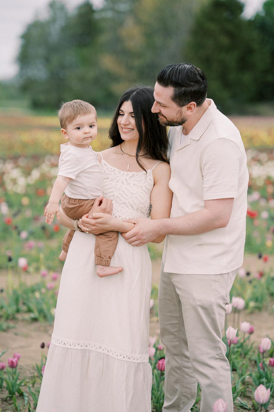 A family enjoys a day out in a colorful tulip field, capturing a moment of togetherness and joy.
