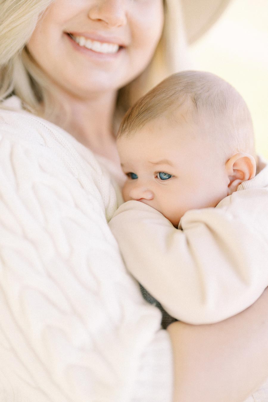 A tender moment captured between a woman and a baby, showcasing warmth and affection.