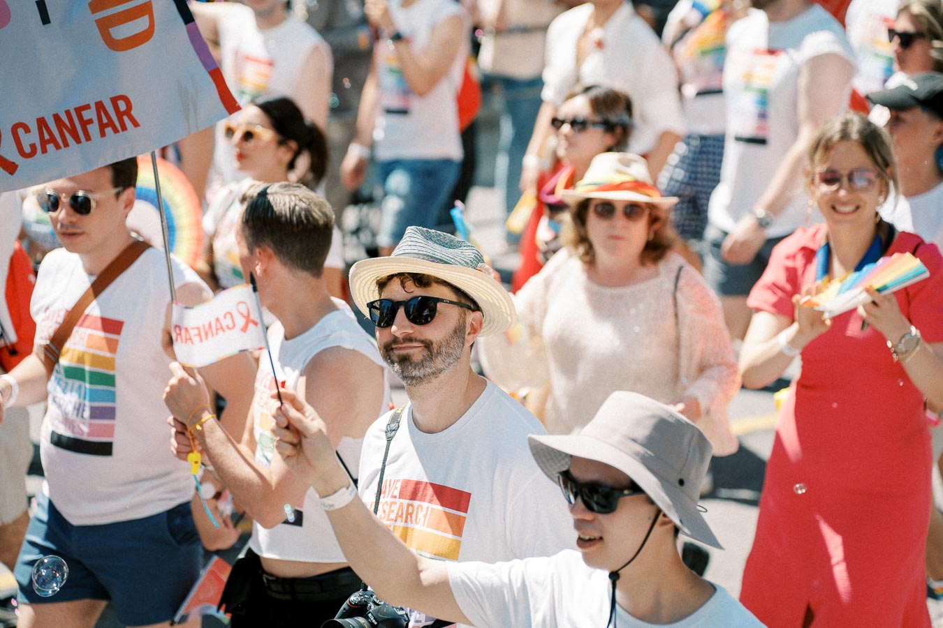 Participants in a pride parade celebrate with colorful attire and flags, promoting inclusivity and diversity.
