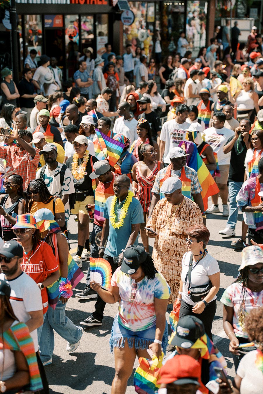 A vibrant pride parade with participants celebrating diversity and inclusion, adorned in rainbow colors and festive attire.