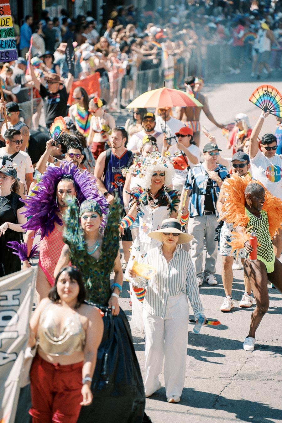 Participants in a lively pride parade, adorned in colorful costumes and rainbow-themed accessories, celebrate diversity and inclusion.