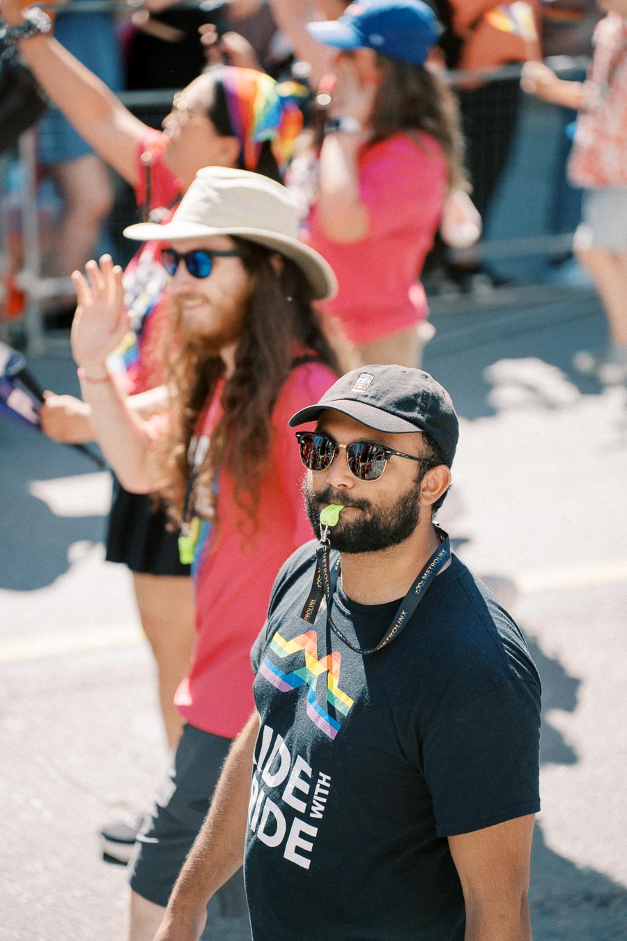 Participants at a pride parade wearing colorful attire and accessories, celebrating diversity and inclusion.