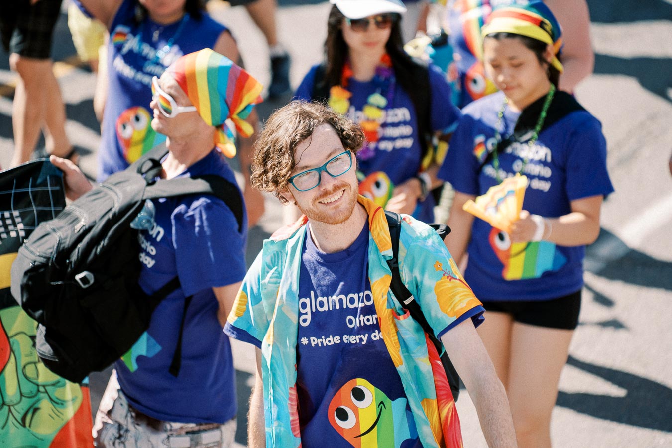 Participants in a pride parade wearing vibrant clothing and rainbow-themed accessories, celebrating diversity and inclusion.