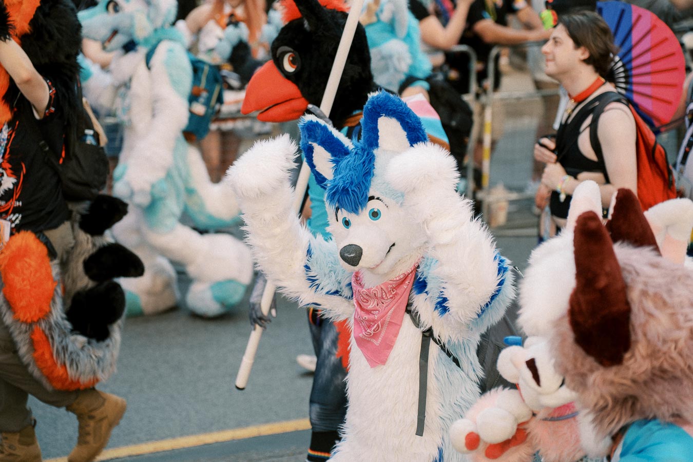 Participants in vibrant animal costumes march in a lively parade, showcasing colorful and creative designs.