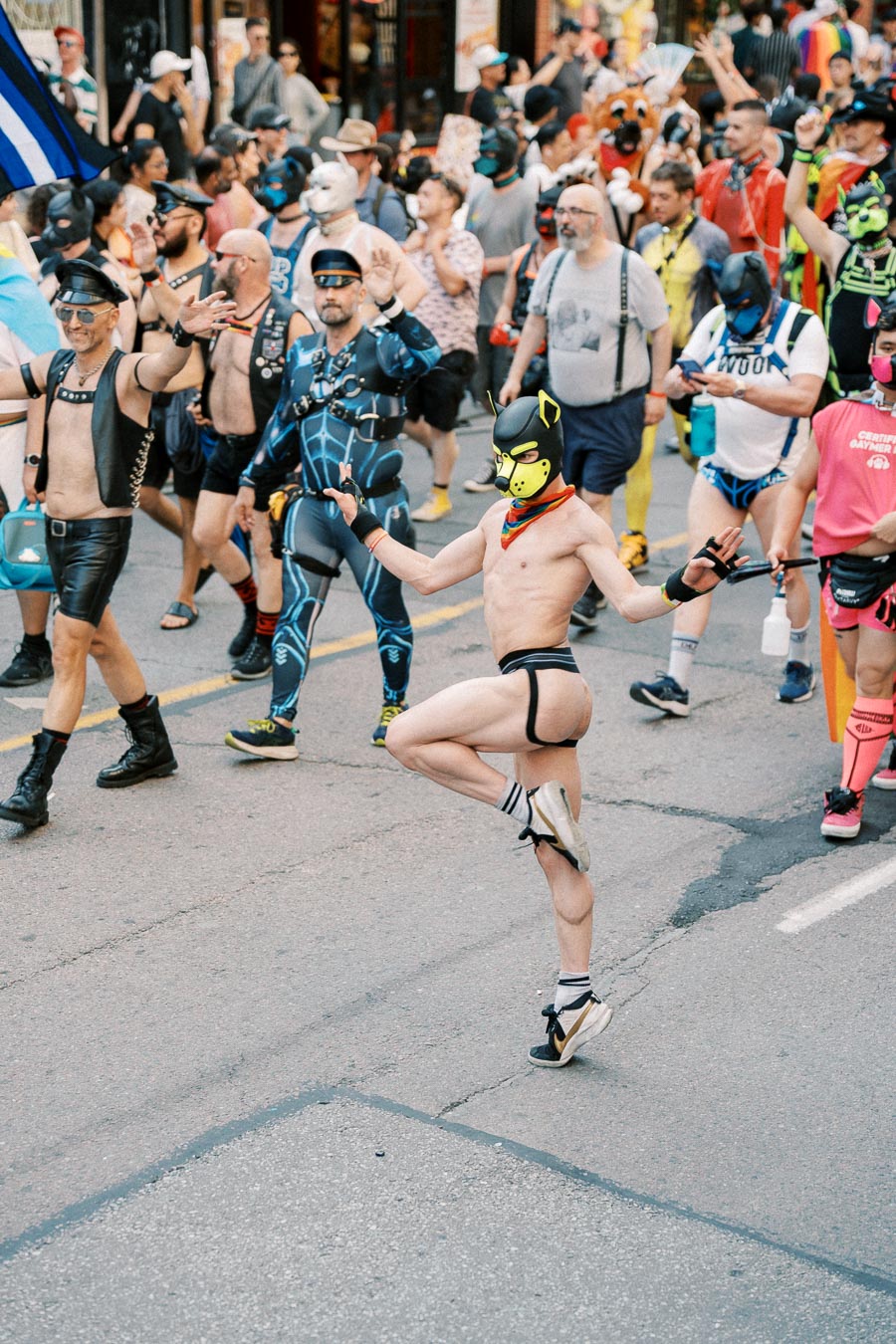 Participants in vibrant costumes and masks take part in a lively parade, showcasing creativity and diversity.