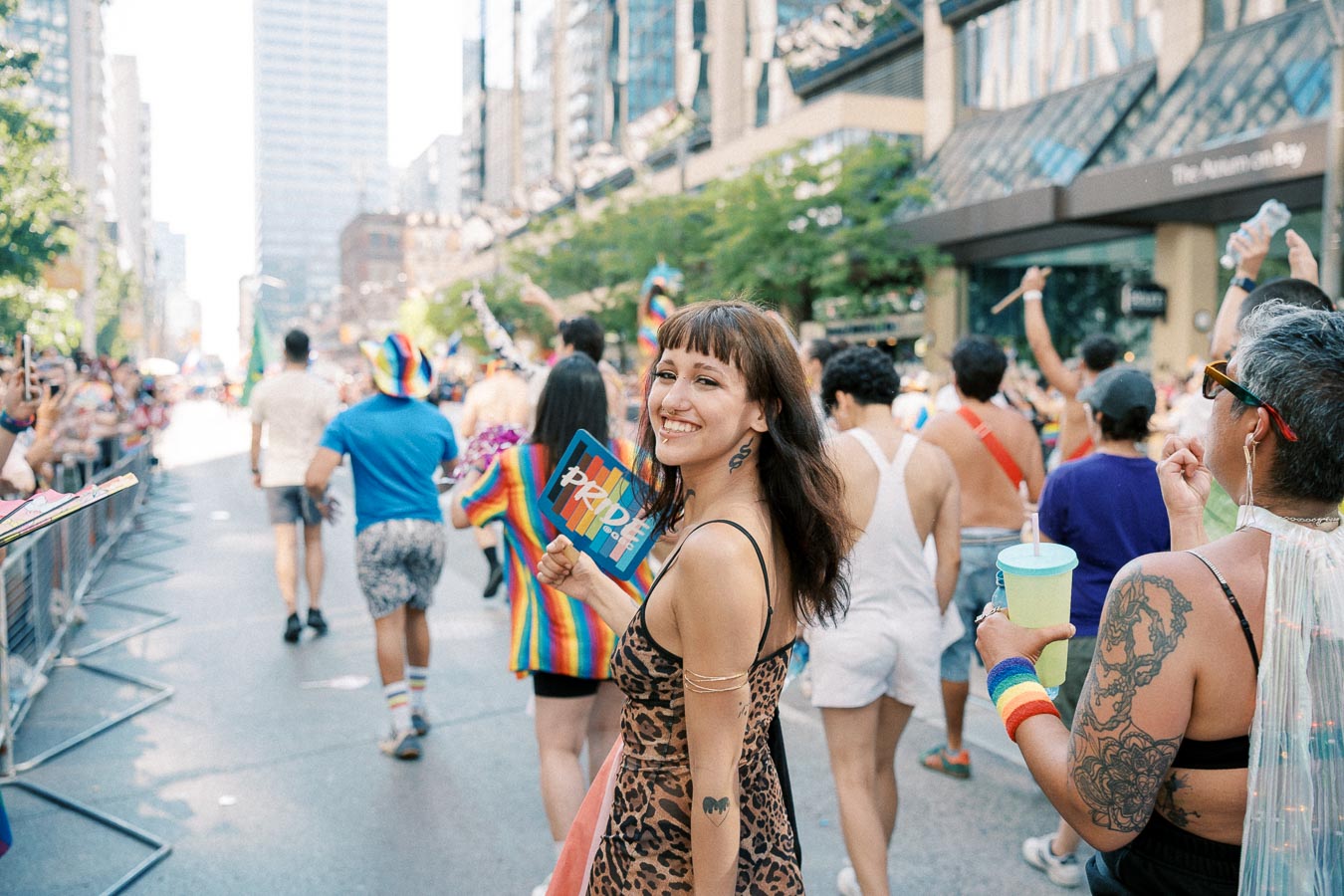 Participants enjoy a vibrant pride parade, showcasing colorful outfits and joyful expressions.