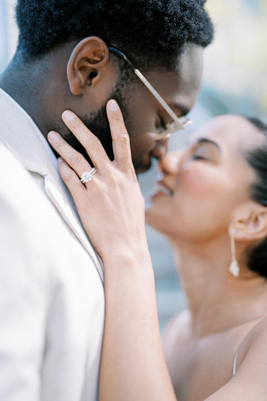 Romantic couple sharing an intimate moment, close-up of woman with engagement ring on her hand, about to kiss man softly.