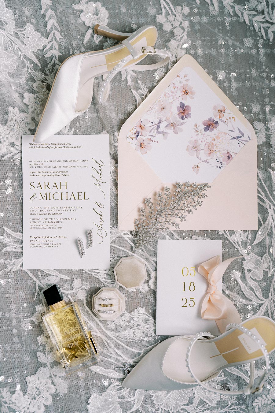 Elegant wedding flat lay featuring bridal shoes, floral invitation, perfume, rings, lace background, and decorative elements. Perfect for showcasing wedding details and inspiration.