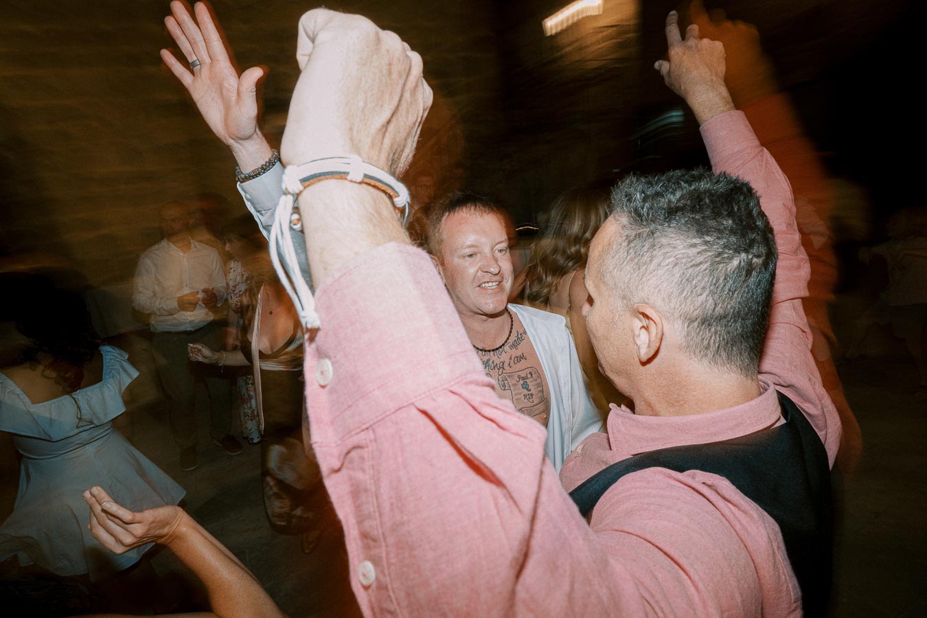 A lively group of people dancing enthusiastically at a party.
