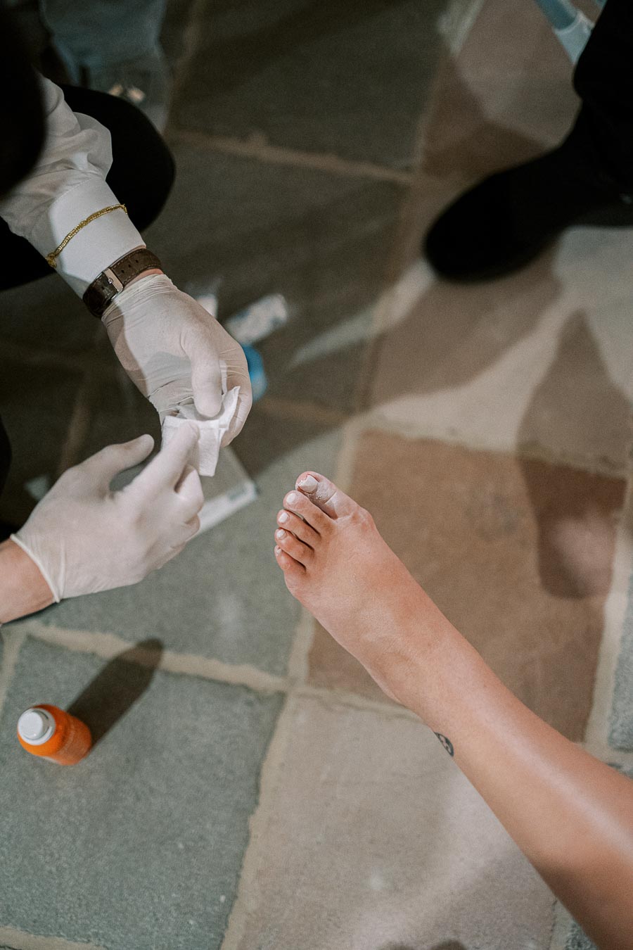 Person applying a bandage to a toe, emphasizing foot care with medical treatment.