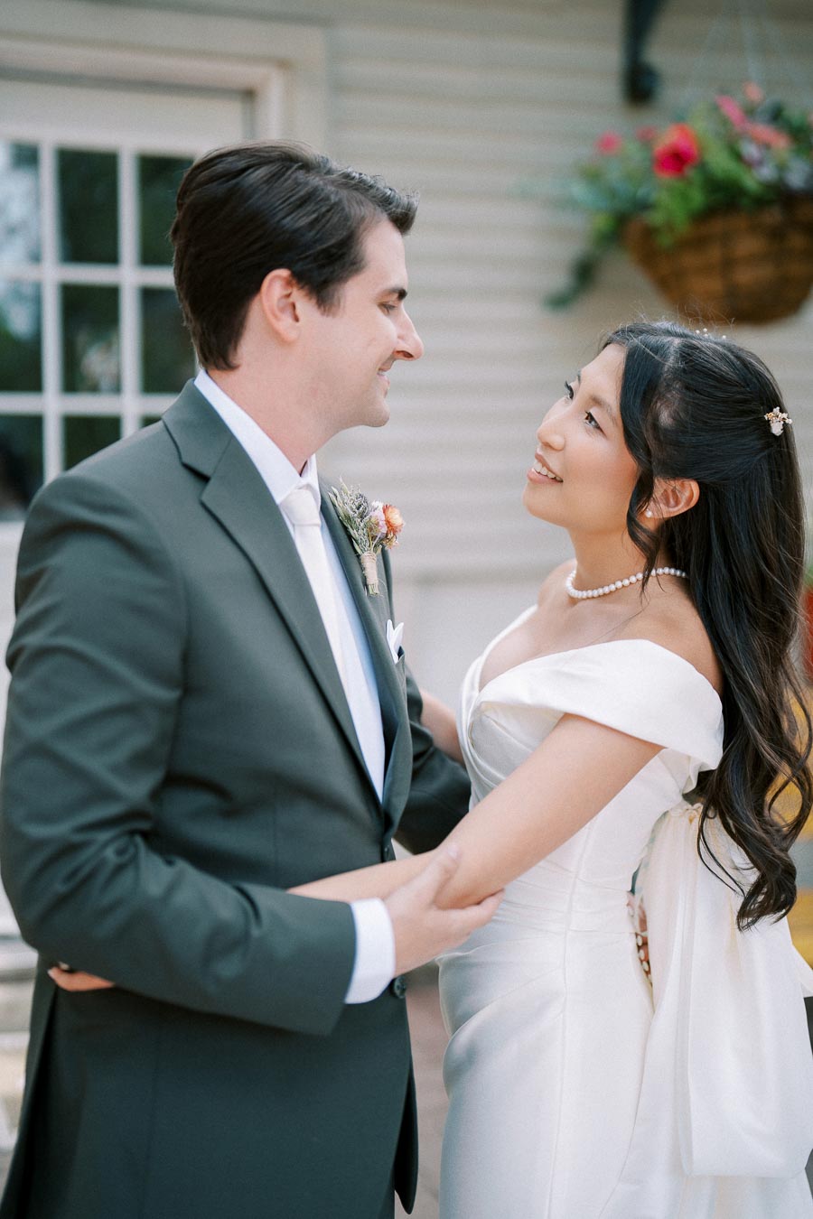 Happy bride and groom gazing into each other's eyes during an outdoor wedding ceremony.