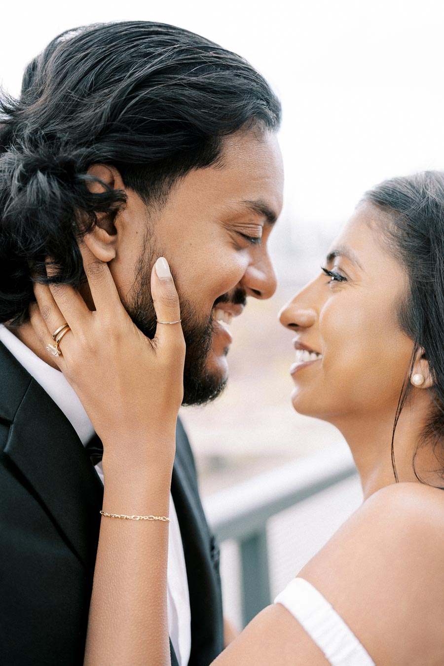 Romantic close-up of a couple smiling and embracing, with focus on their expressions of love and connection; ideal for themes of romance, relationships, and happiness