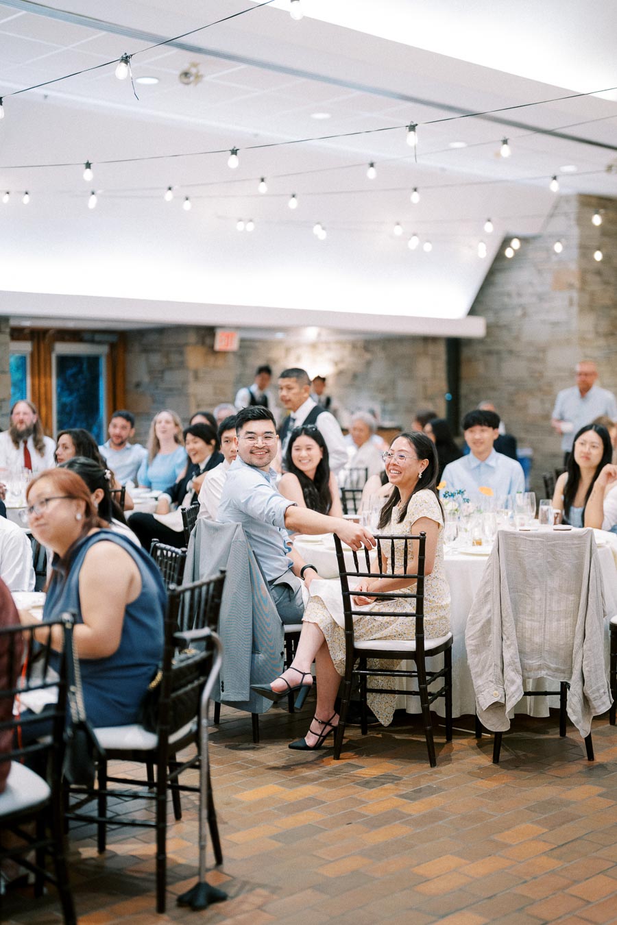 Guests enjoy a formal event with elegant decor and ambient lighting.