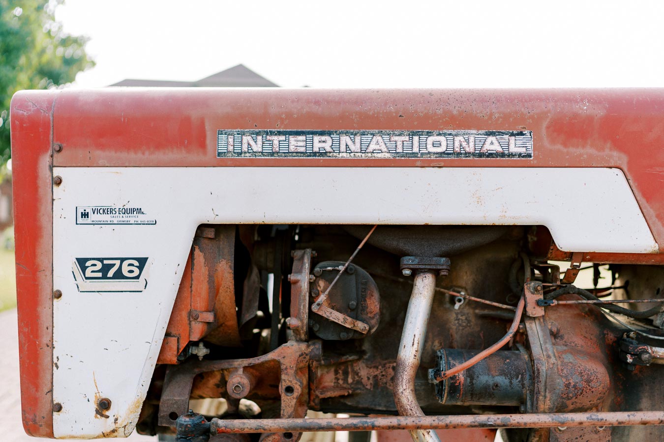 Close-up of a vintage International 276 tractor engine with visible rust and wear.