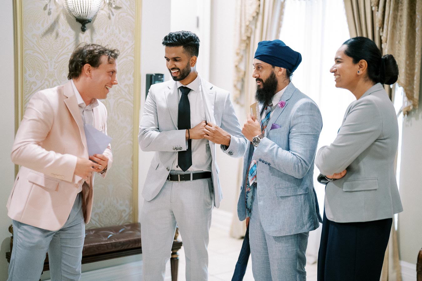 Group of diverse business professionals engaged in conversation at an upscale event.