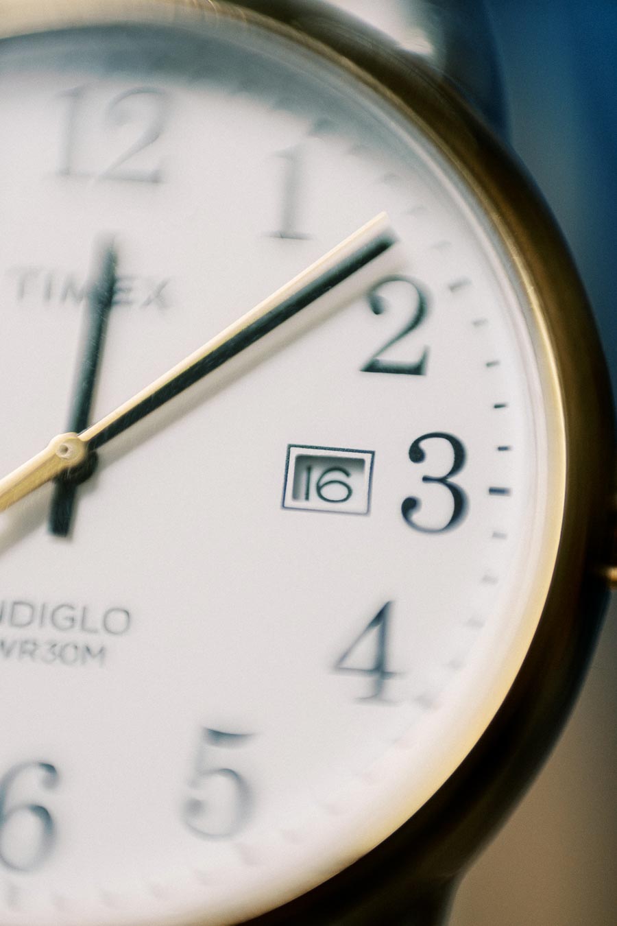 Close-up view of a classic analog clock face displaying the time as 2:53, with a white background and black numerals.