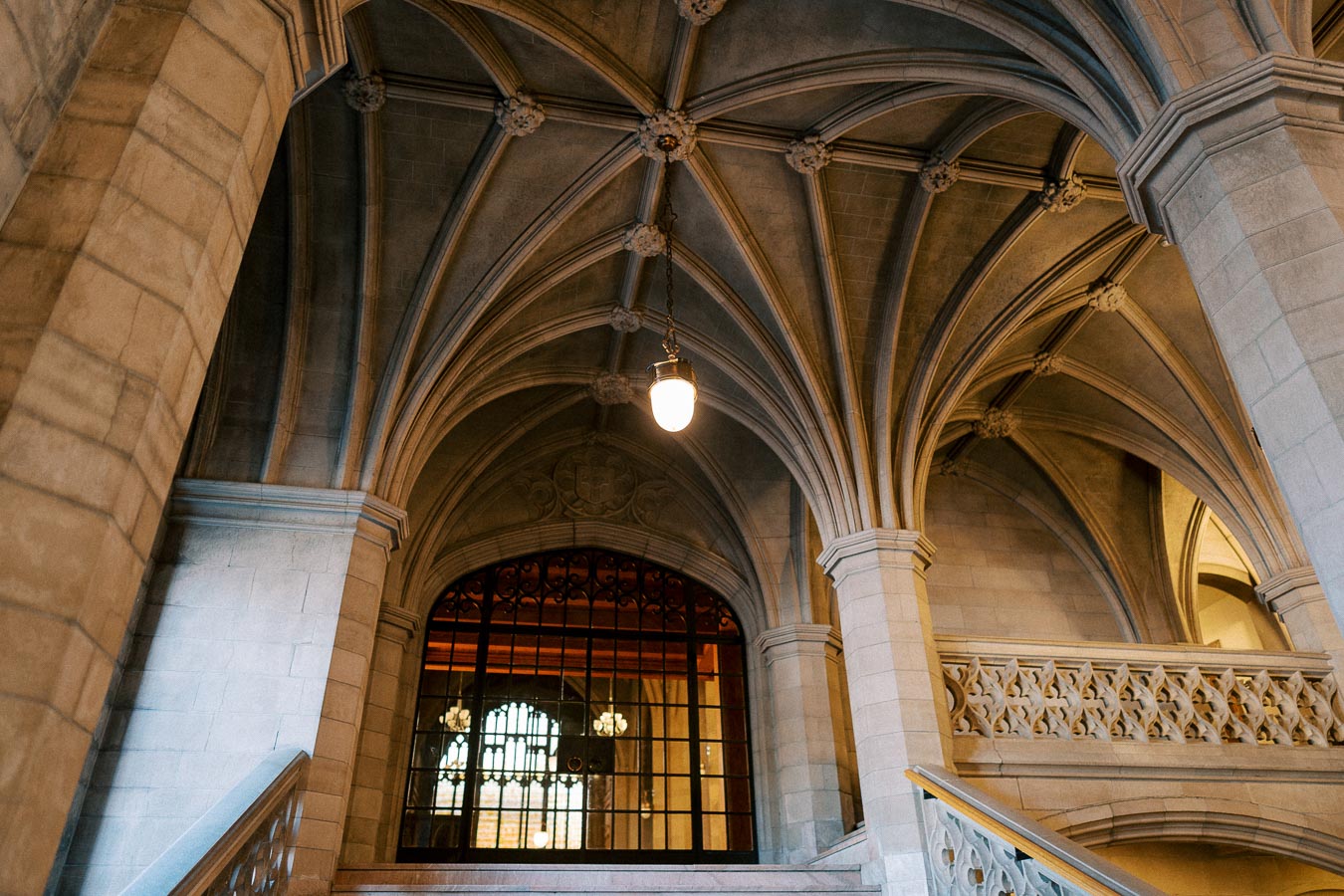 Intricate gothic architecture featuring vaulted ceilings and ornate stone pillars in a historic building interior.