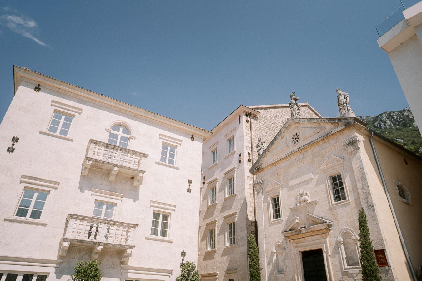 Elegant historic European architecture with detailed stone façades under a clear blue sky.