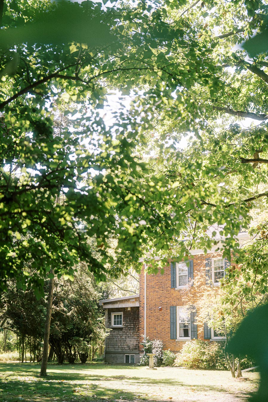 Alexandra and Pavel’s wedding day in Niagara-on-the-Lake, Ontario, featuring getting ready and a first look at Toad Hall Cottages and a heartfelt orchard ceremony and reception at Ironwood Cider House. Documentary, editorial wedding photography by a Toronto Wedding Photographer.