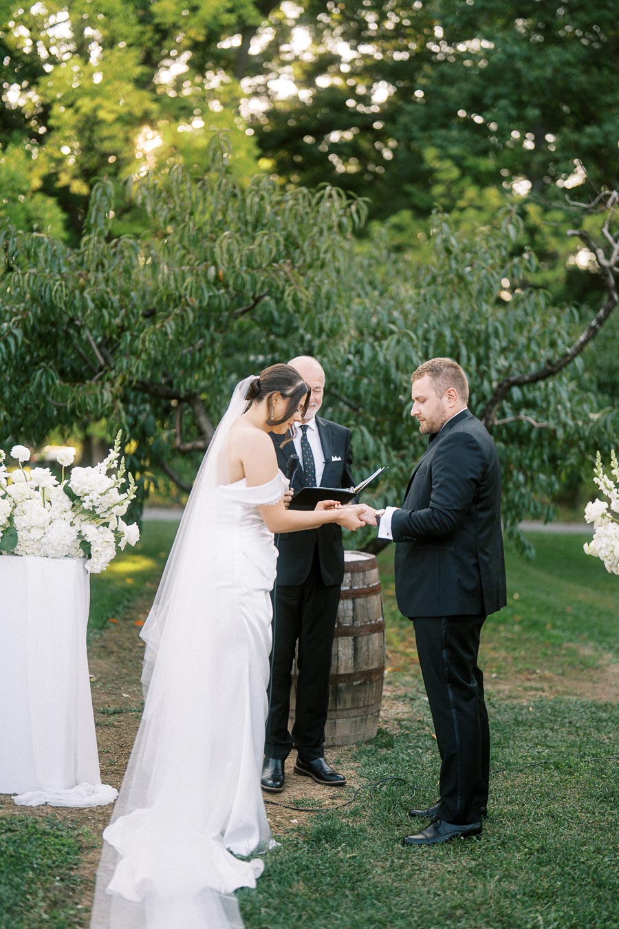 Alexandra and Pavel’s wedding day in Niagara-on-the-Lake, Ontario, featuring getting ready and a first look at Toad Hall Cottages and a heartfelt orchard ceremony and reception at Ironwood Cider House. Documentary, editorial wedding photography by a Toronto Wedding Photographer.