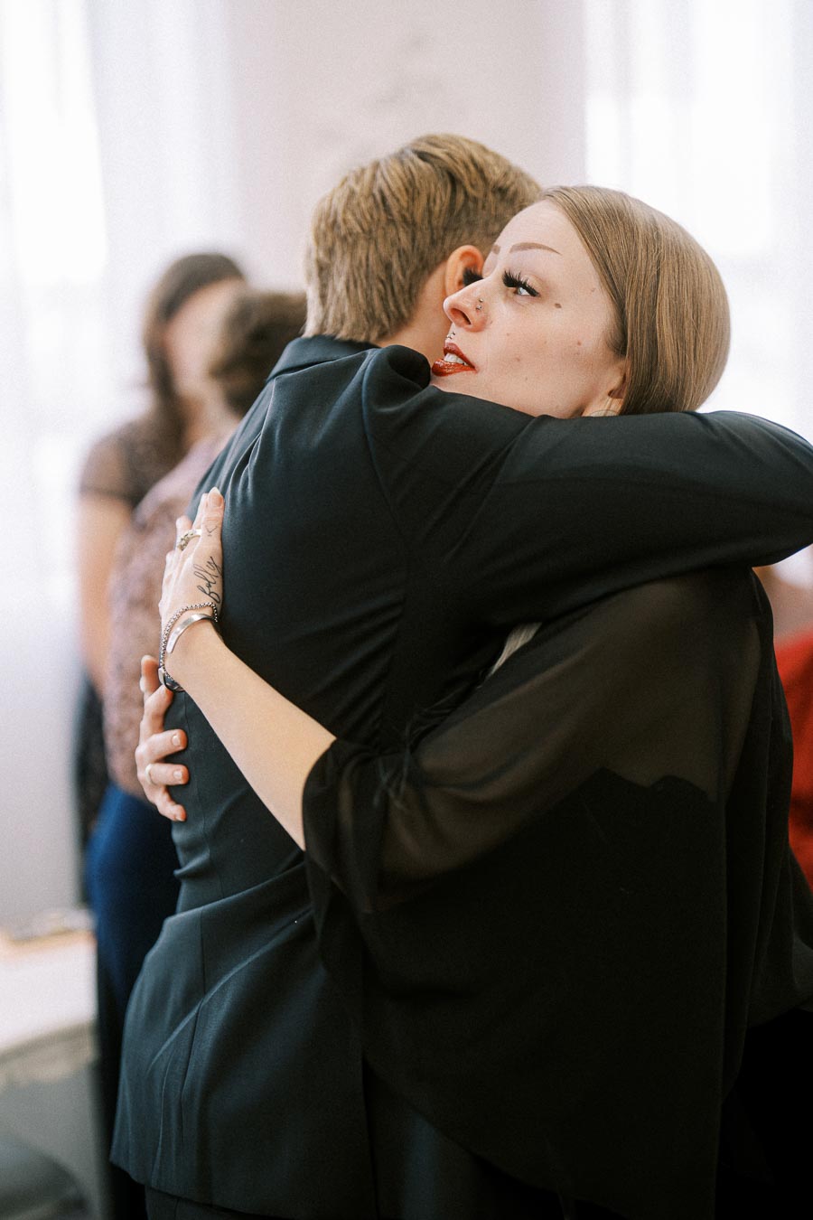 Two people hugging warmly in a heartfelt embrace, conveying emotions of support and affection.