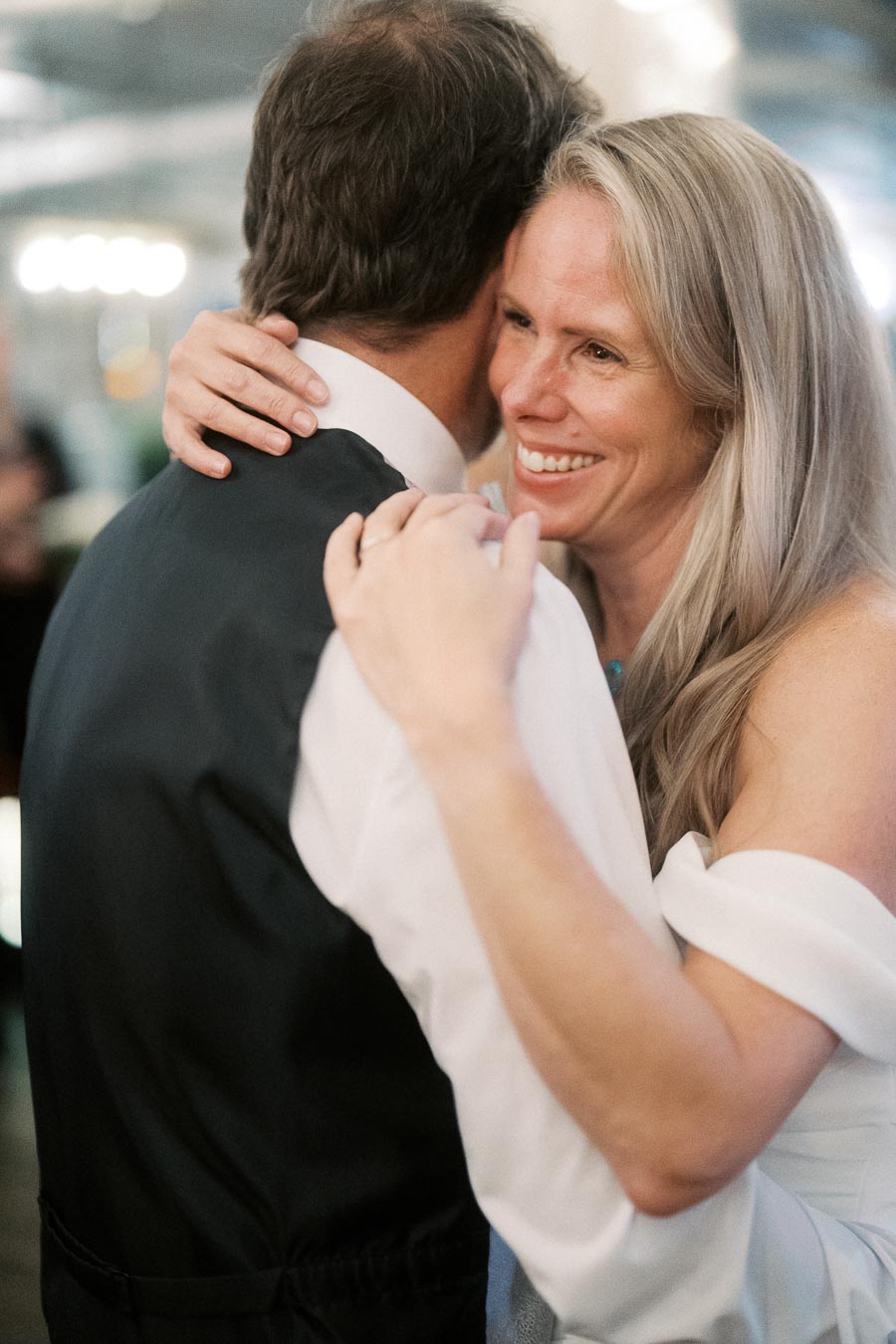 A couple sharing a joyful dance at a wedding reception, highlighting love and happiness.
