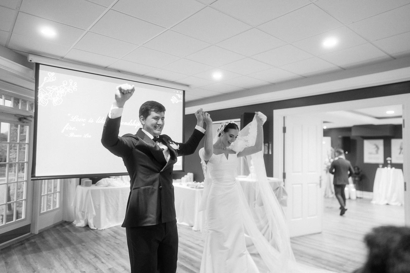 Bride and groom celebrating their wedding day, holding hands joyfully in a reception hall with a romantic quote displayed in the background.
