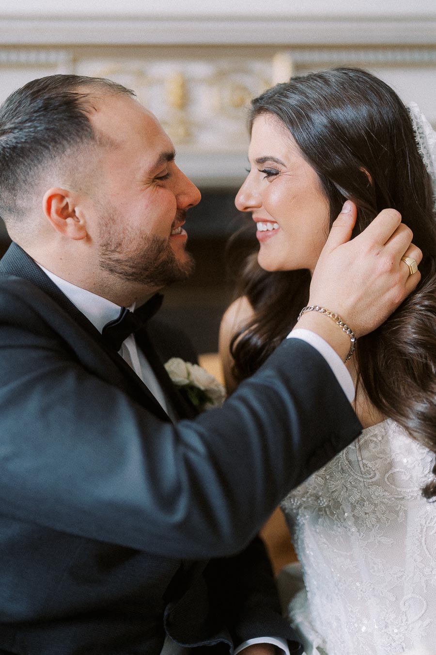 Happy bride and groom sharing a tender moment, dressed elegantly in a wedding gown and suit, celebrating their special day.